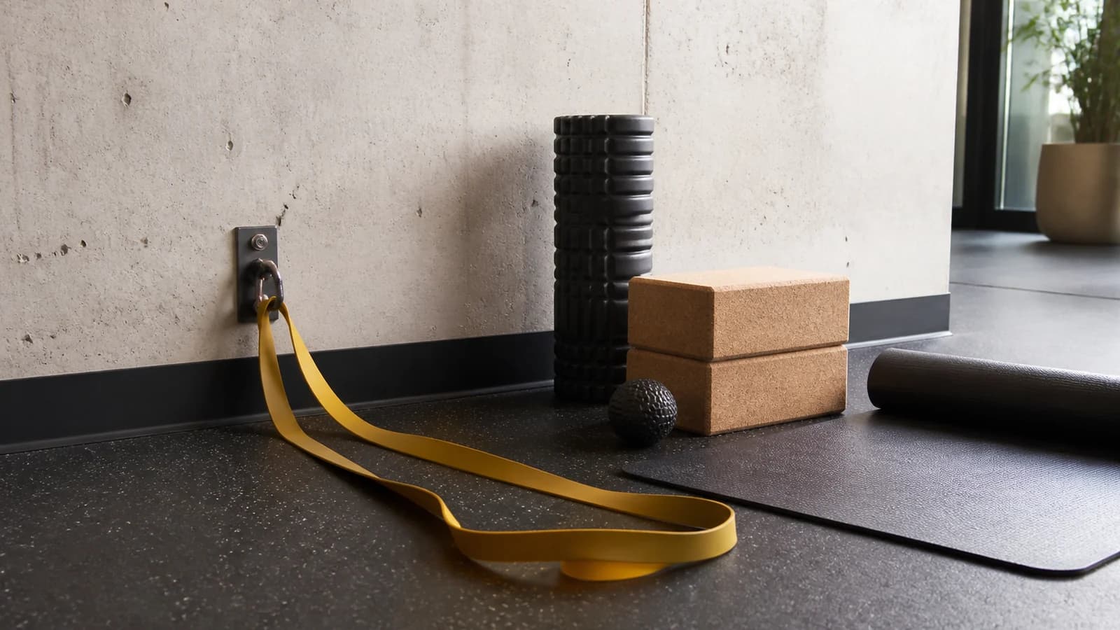Resistance band, cork blocks, foam roller, massage ball and mat in a mobility corner